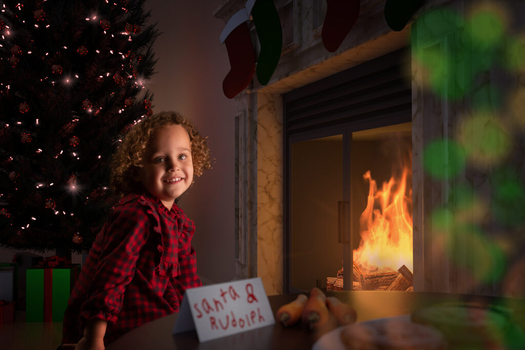 Child with Christmas tree and fireplace in Christmas photo